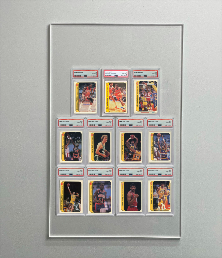 A filled wall display of 11 PSA graded cards